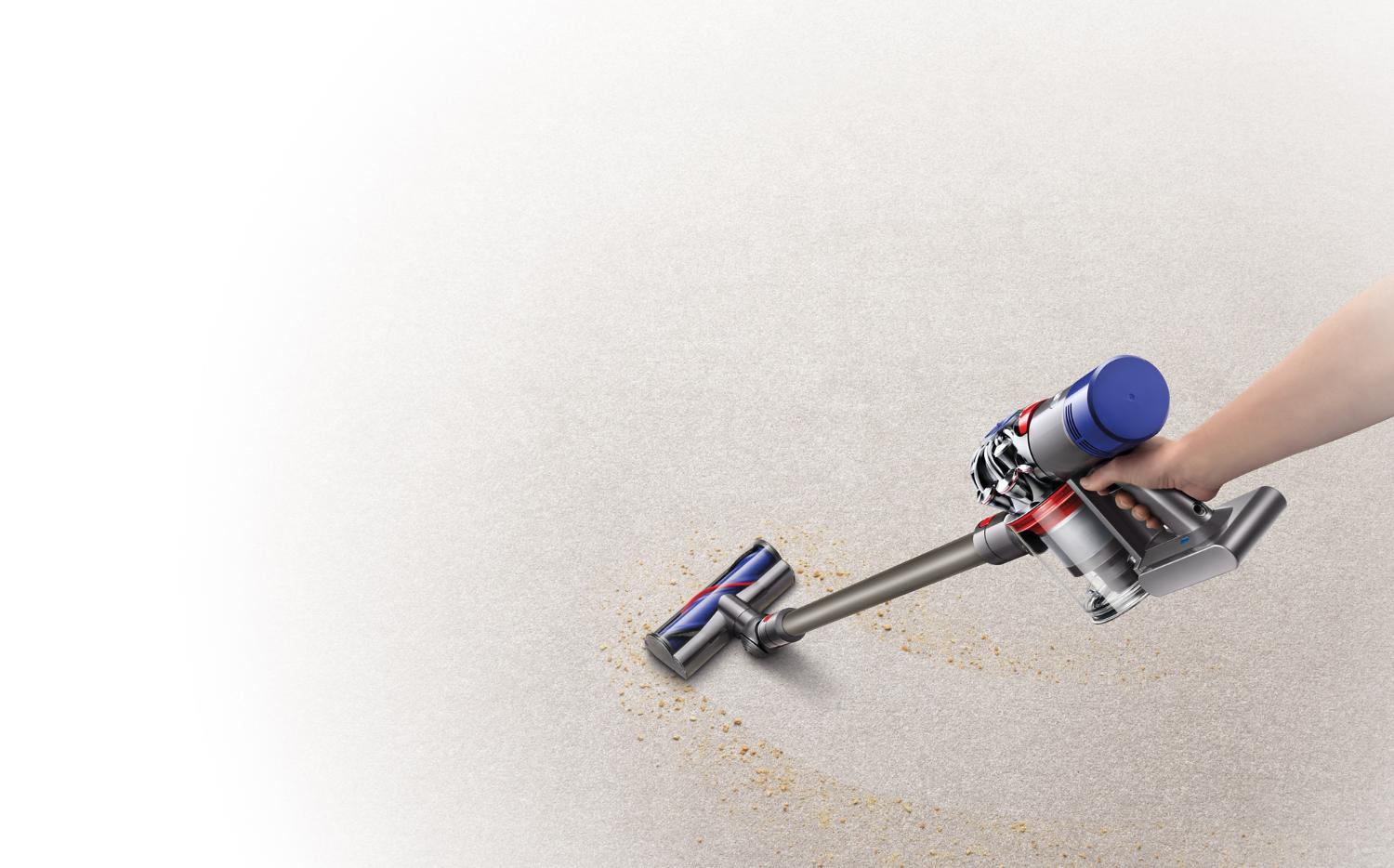 Dyson V8 Animal cordless vacuum being used on carpet